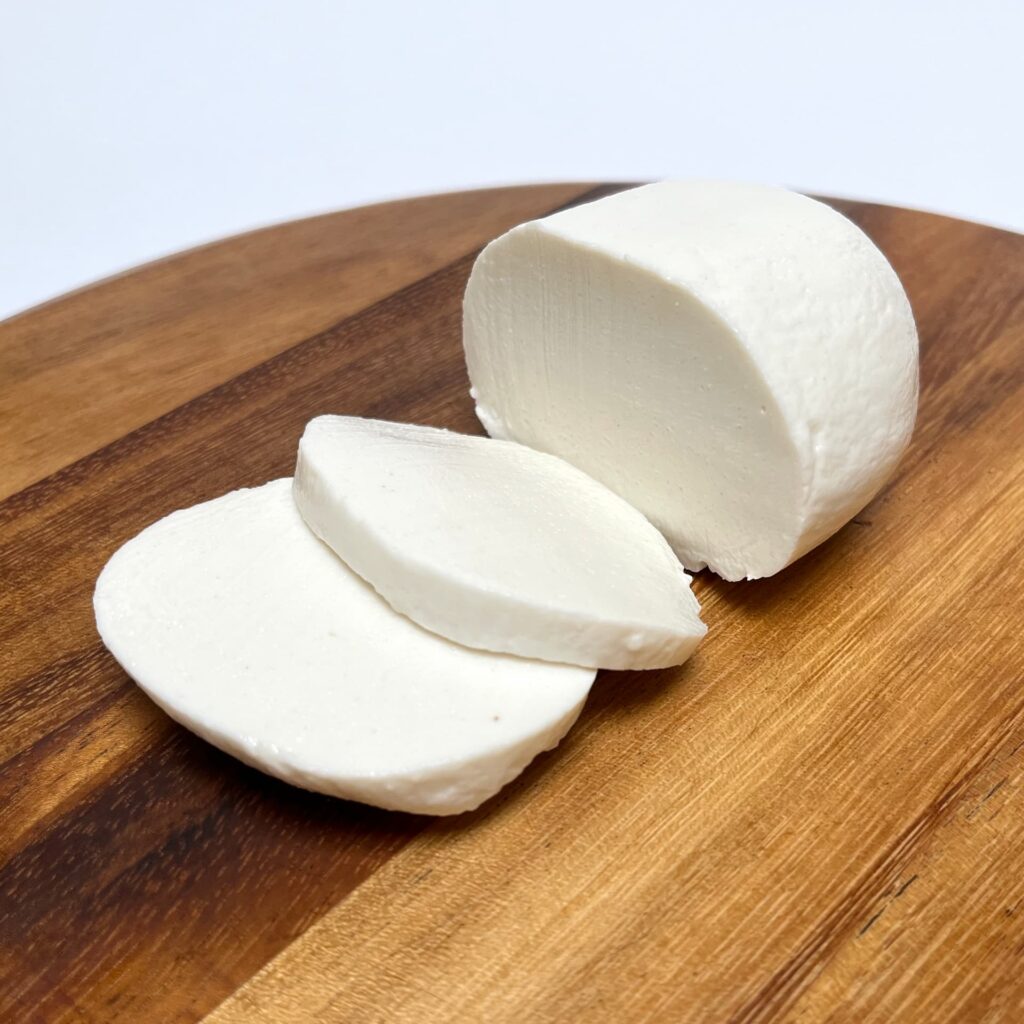 Mozzavella vegan cheese by Zuger Vegan with cut slices