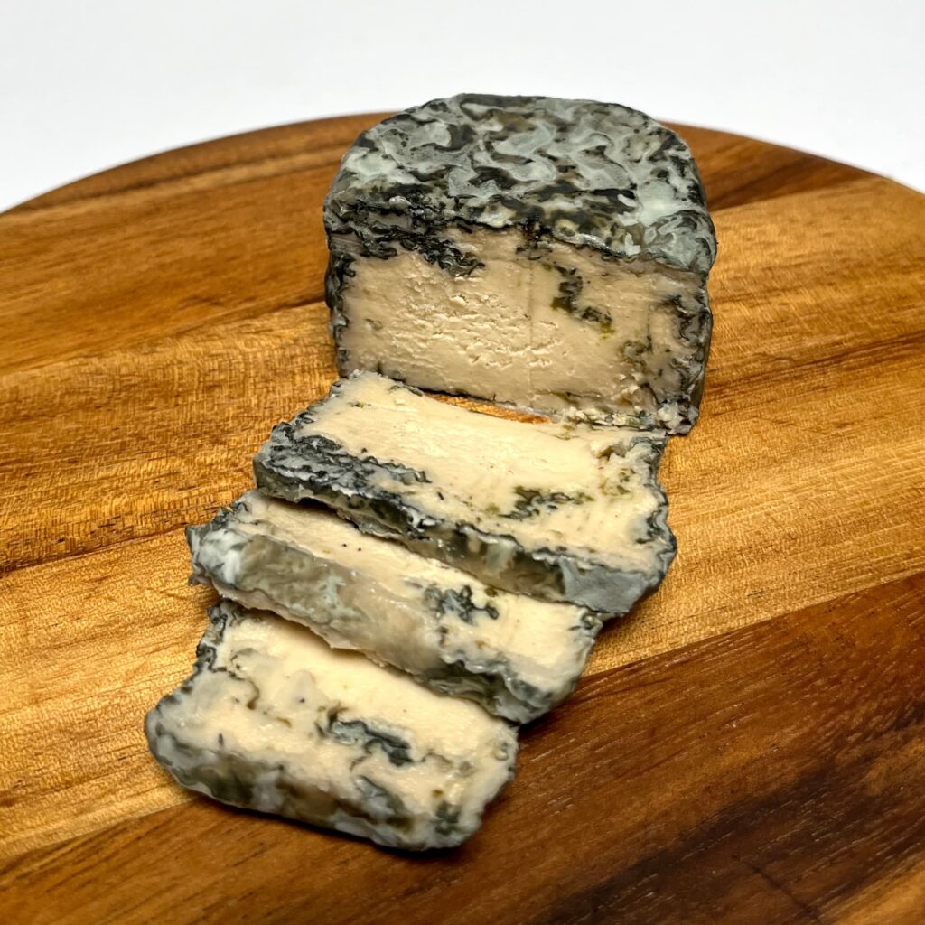 Simply Blue vegan cheese by Nutty Artisan Foods with slices cut off